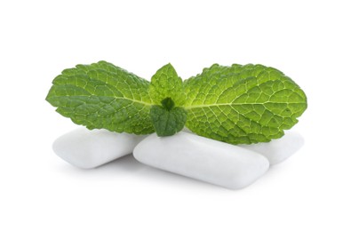 Photo of Three chewing gum pieces and mint on white background