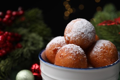 Delicious sweet buns in bowl against blurred background, closeup