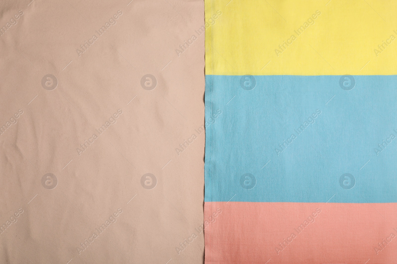 Photo of Soft beach towel on sand, top view. Space for text. Space for text