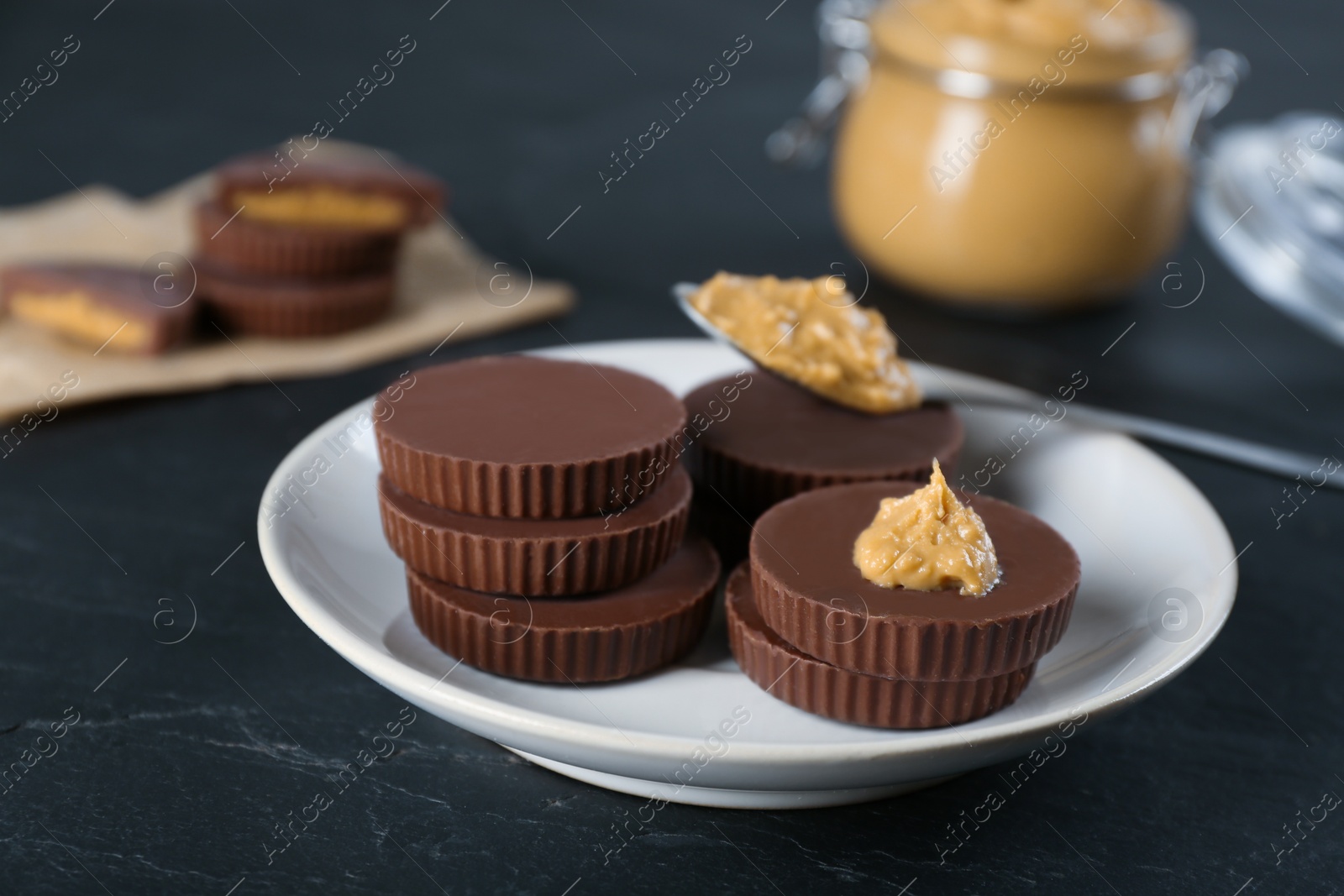 Photo of Delicious peanut butter cups on black table