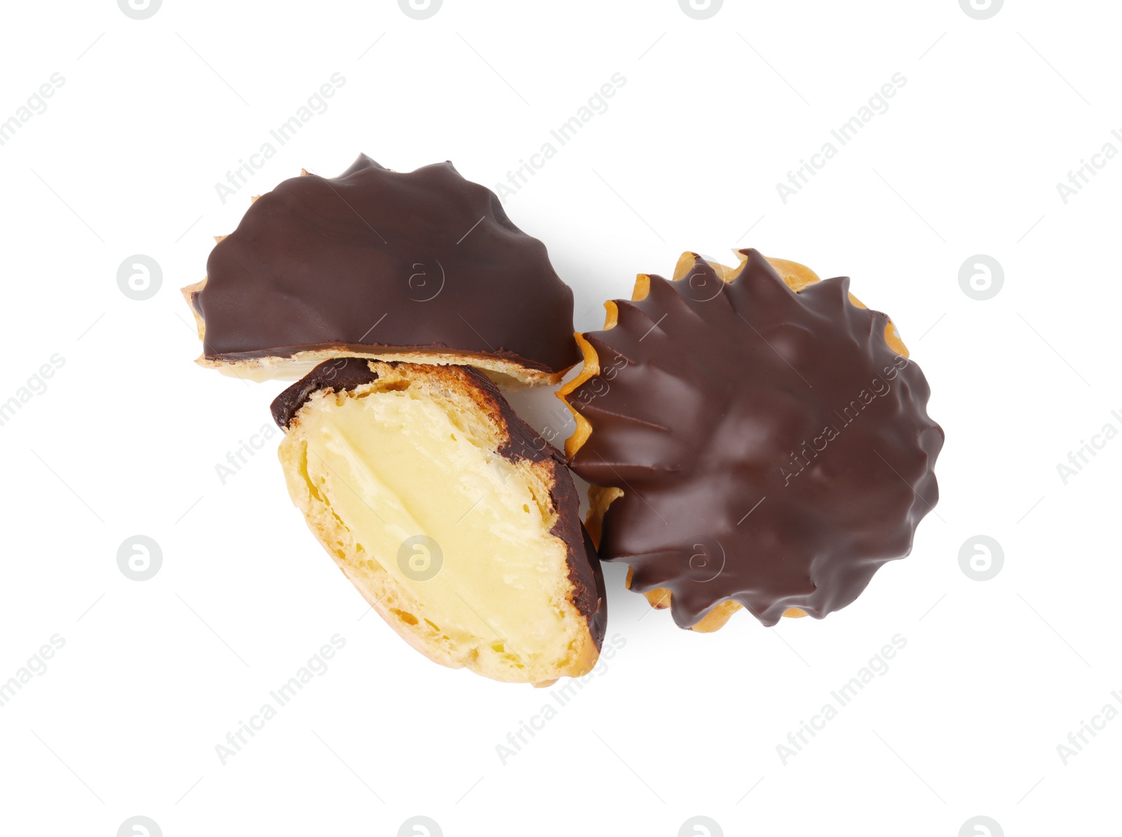 Photo of Delicious profiteroles with chocolate spread and cream isolated on white, top view