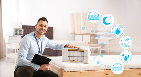 Image of Salesman with section of mattress in furniture store
