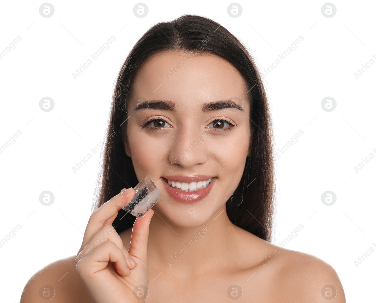 Photo of Young woman with ice cube on white background. Skin care