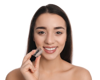 Photo of Young woman with ice cube on white background. Skin care