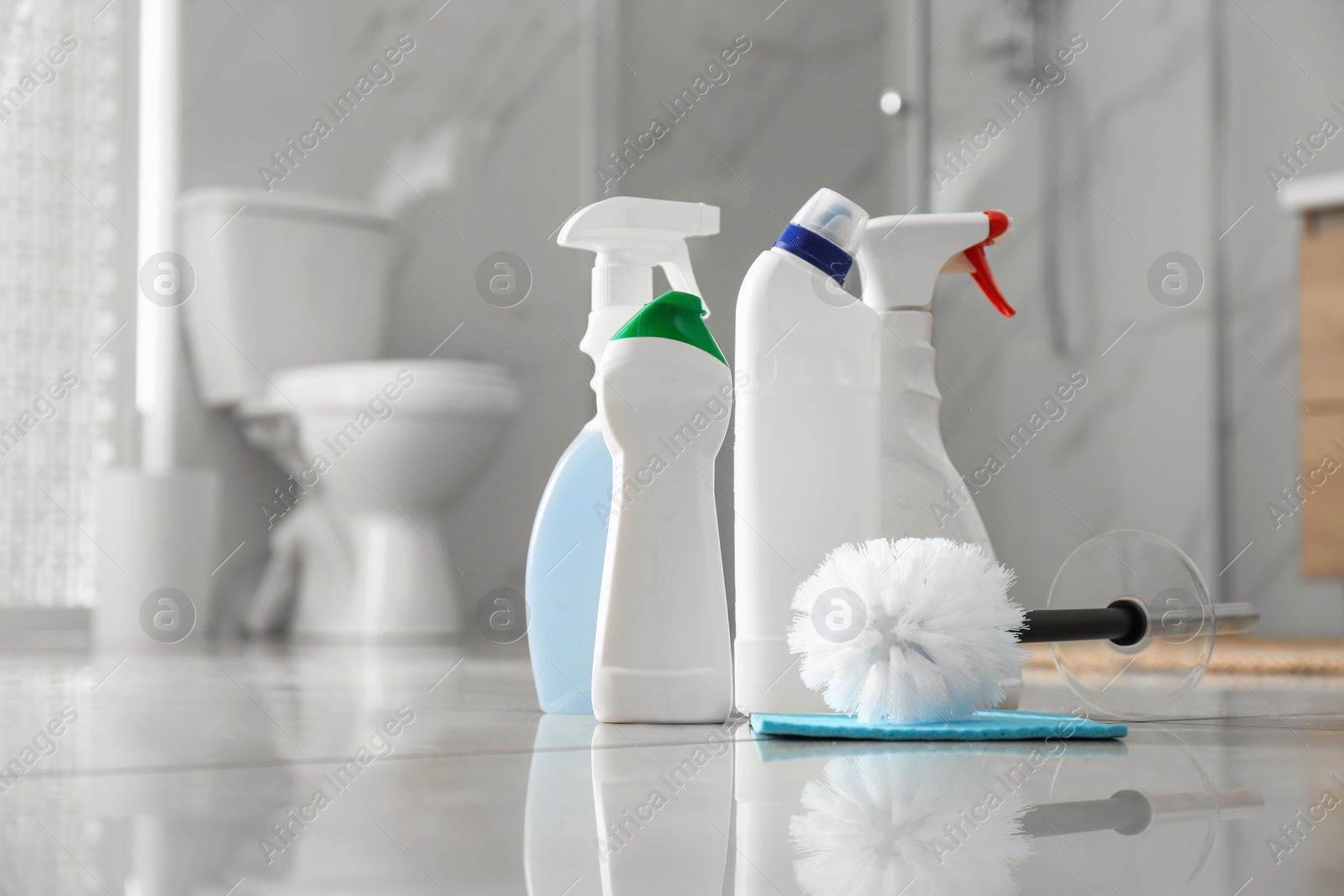 Photo of Cleaning supplies and toilet bowl in bathroom. Space for text