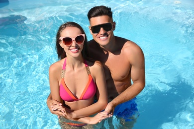 Photo of Happy couple in outdoor pool on sunny summer day