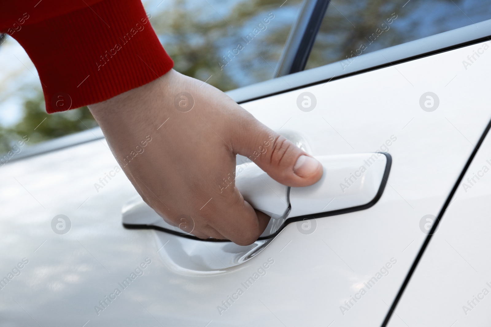 Photo of Closeup view of man opening car door outdoors