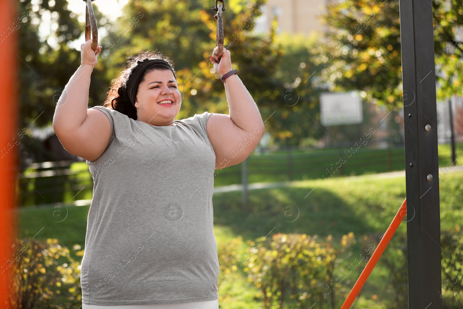 Photo of Beautiful overweight woman training on sports ground