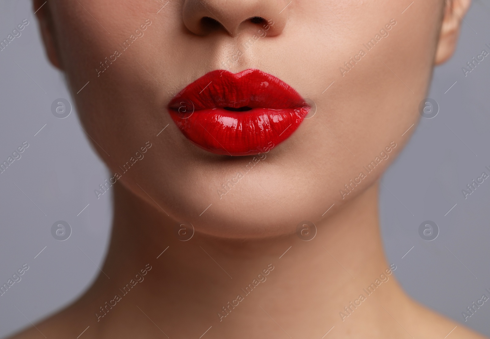 Photo of Closeup view of beautiful woman puckering lips for kiss	on grey background