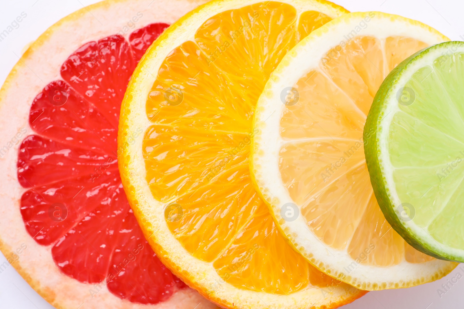 Photo of Slices of fresh ripe citrus fruits as background, top view