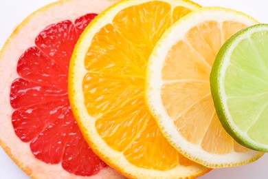 Slices of fresh ripe citrus fruits as background, top view