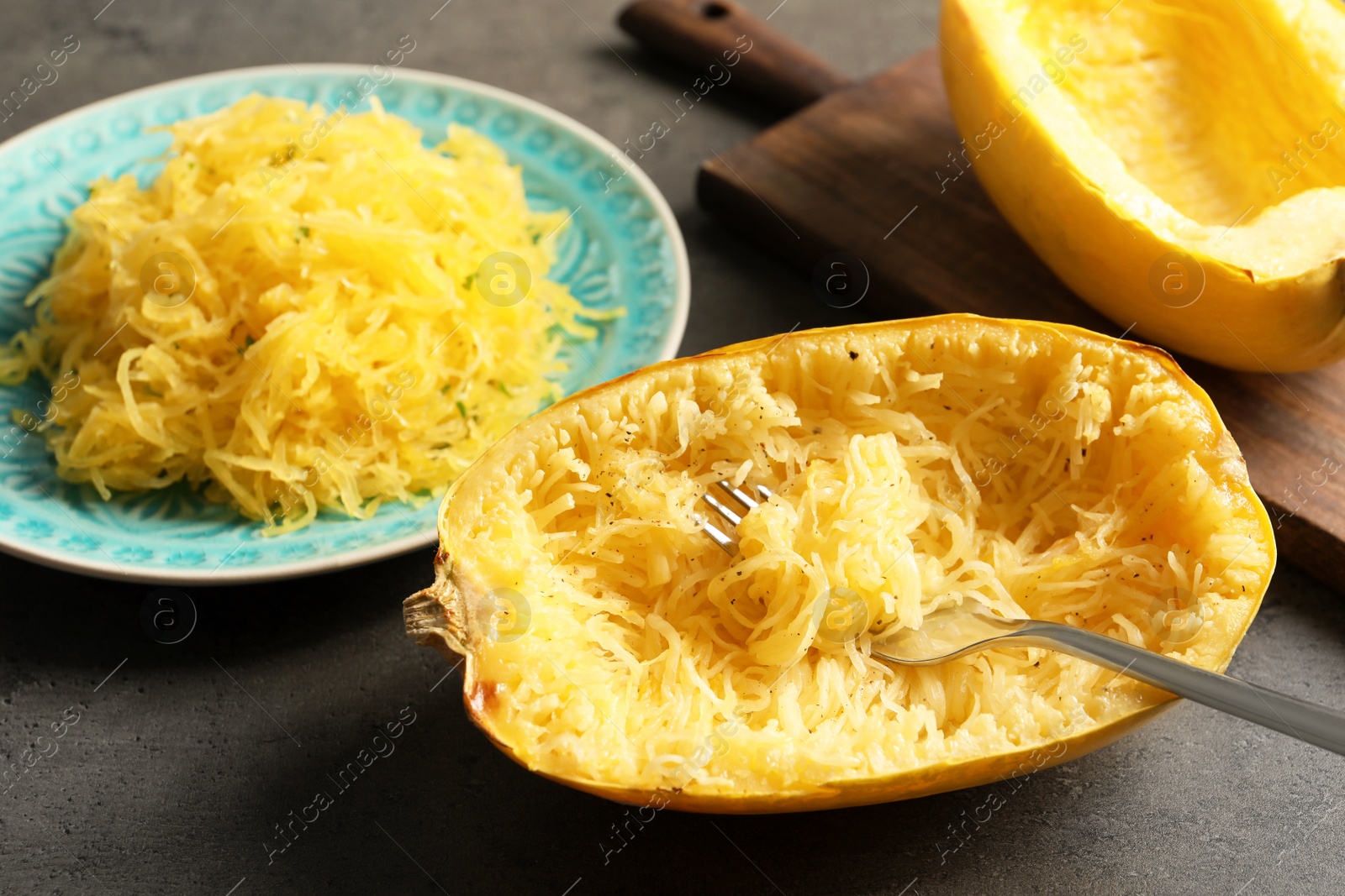 Photo of Cooked spaghetti squash and fork on table