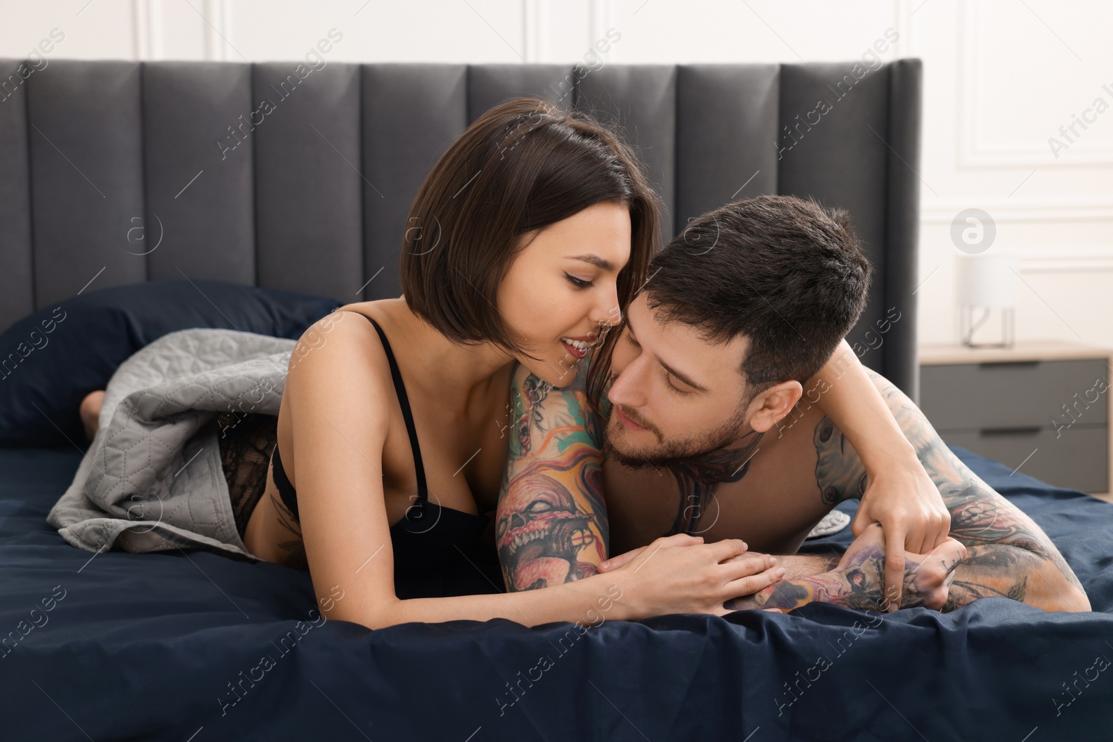 Photo of Passionate couple having sex on bed at home