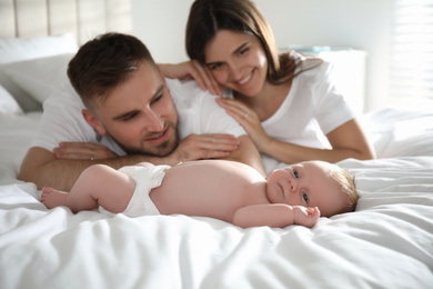 Happy couple with their newborn baby at home