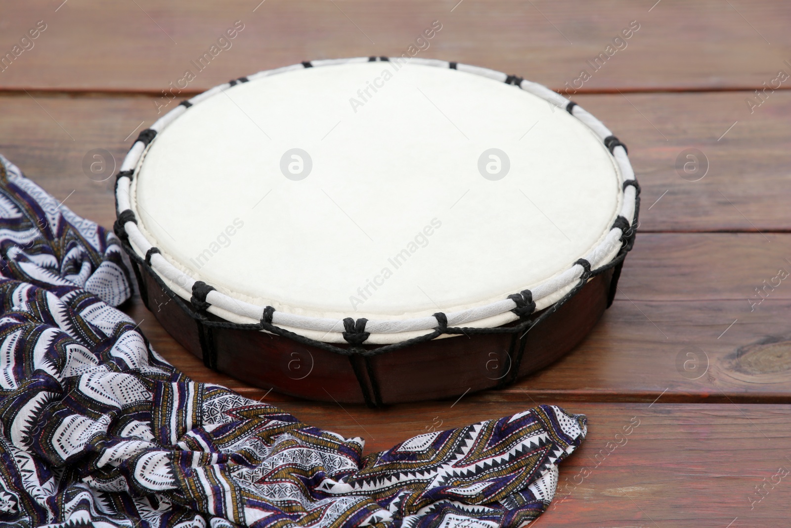 Photo of Modern drum on wooden table. Musical instrument