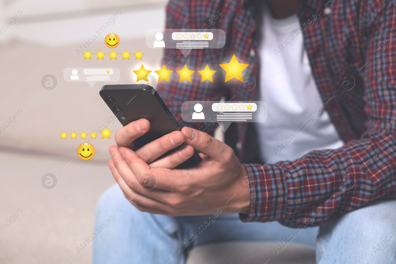 Image of Man leaving service feedback with smartphone outdoors, closeup. Stars and emoticons near device