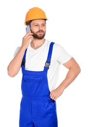 Professional repairman in uniform talking on smartphone against white background