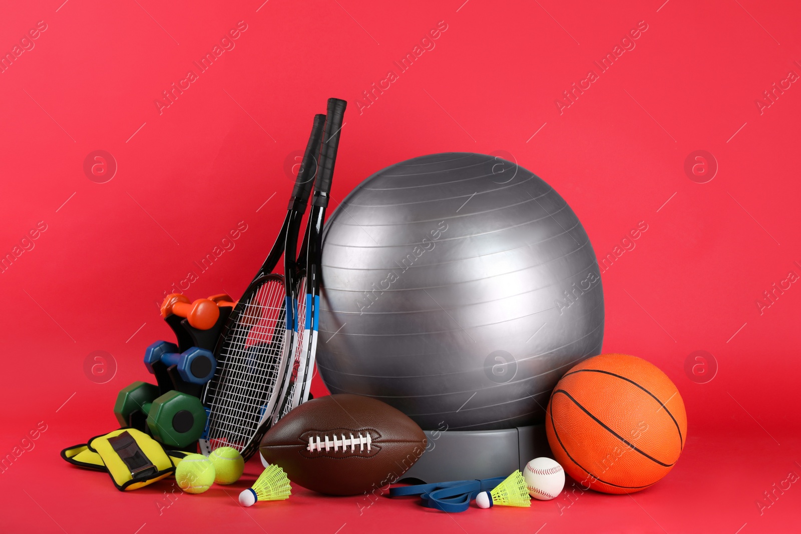 Photo of Set of different sports equipment on red background