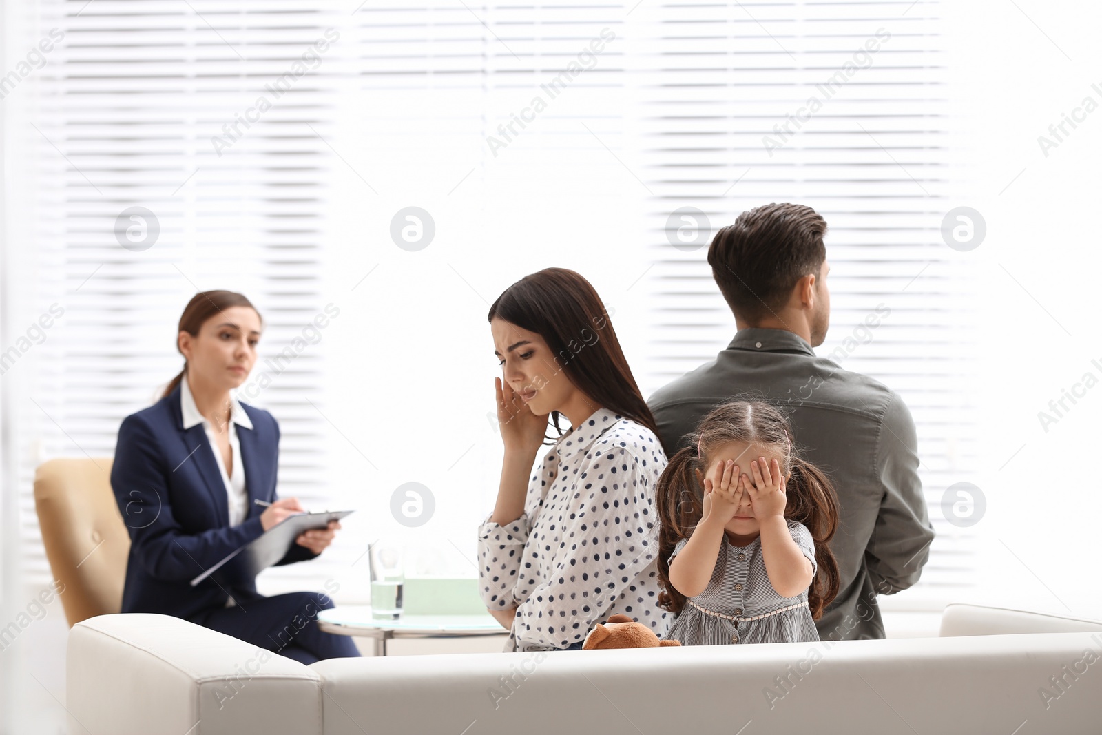 Photo of Professional psychologist working with family in office