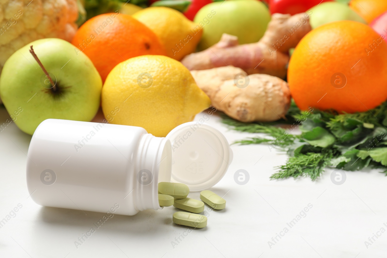 Photo of Dietary supplements in plastic bottle and products on white table. Space for text