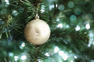 Photo of Beautiful holiday bauble hanging on Christmas tree, closeup