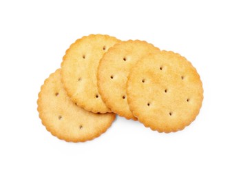 Many crispy crackers isolated on white, top view. Delicious snack