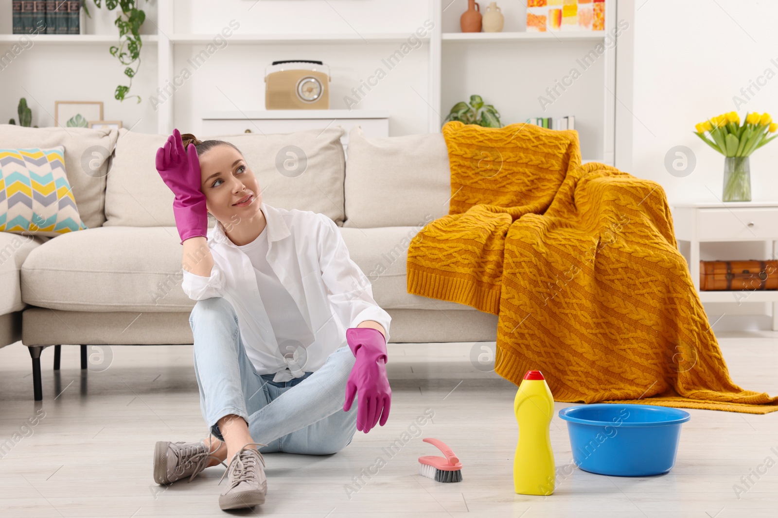 Photo of Spring cleaning. Young woman tidying up living room at home