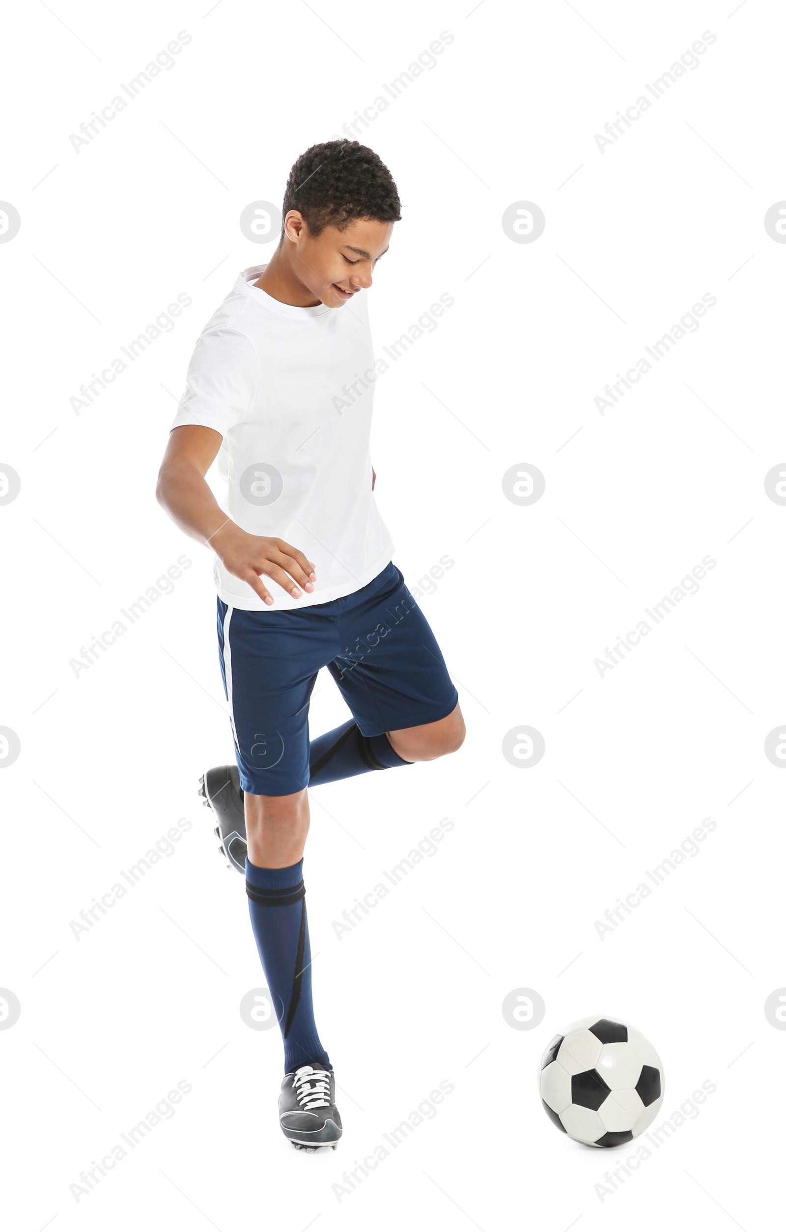 Photo of Teenage African-American boy playing football on white background