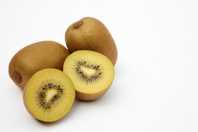 Photo of Whole and cut ripe yellow kiwis on white background