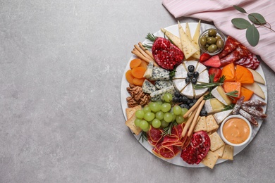 Assorted appetizers served on light grey table, flat lay. Space for text