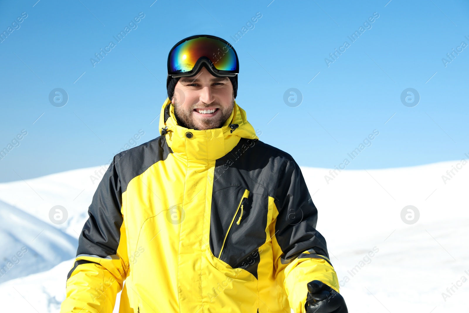 Photo of Happy young man in mountains. Winter vacation