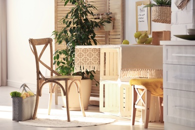 Photo of Modern kitchen interior with wooden crates as eco furniture