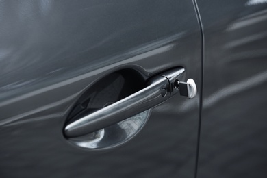 Closeup view of car door with key in lock