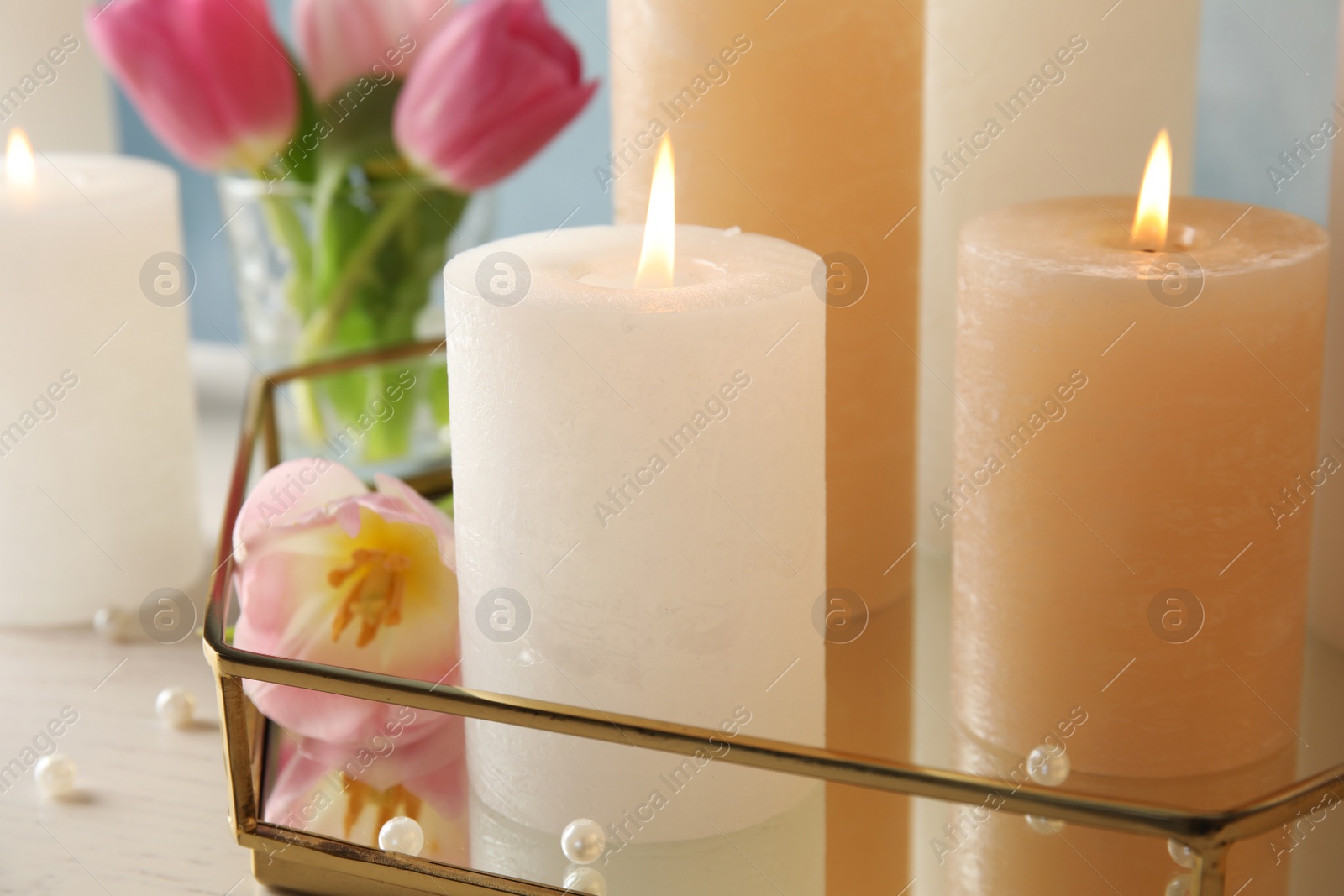 Photo of Composition with burning candles on table, closeup