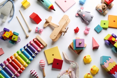 Flat lay composition with different toys on white background