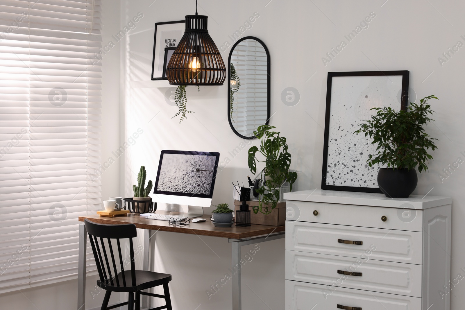 Photo of Cozy workspace with computer on wooden desk at home