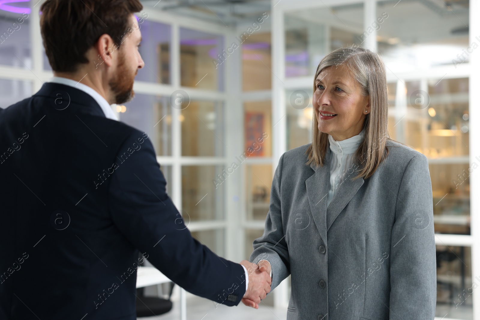 Photo of Lawyer shaking hands with client in office