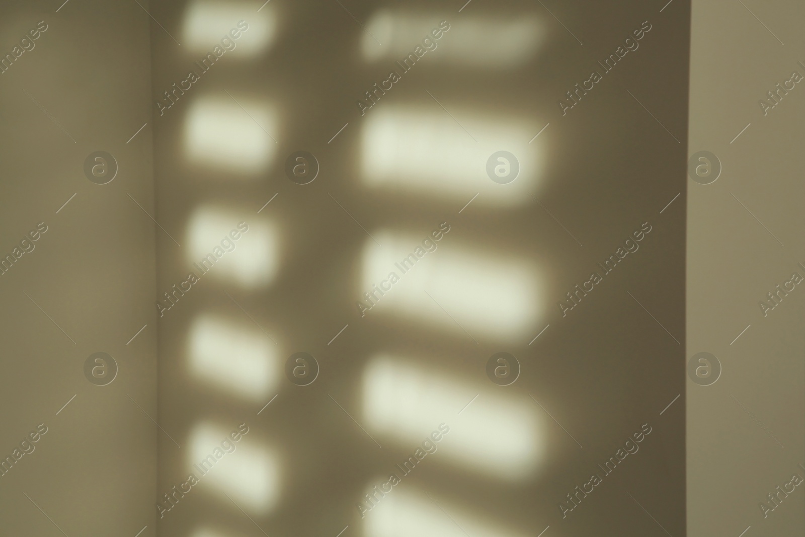 Photo of Lines made of light and shadows on white wall