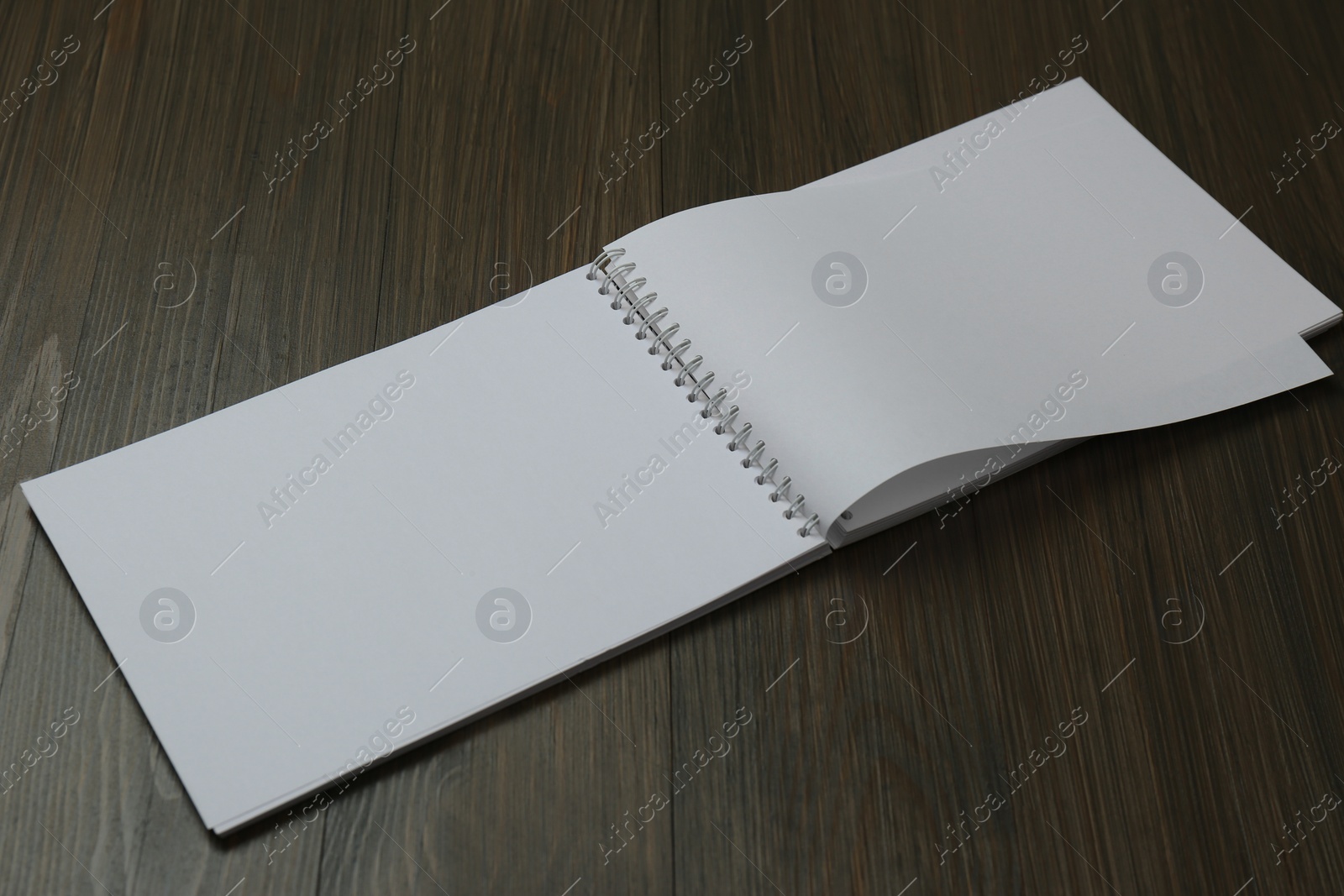 Photo of Blank paper brochure on wooden table. Mockup for design