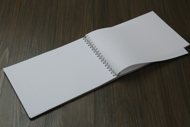 Blank paper brochure on wooden table. Mockup for design