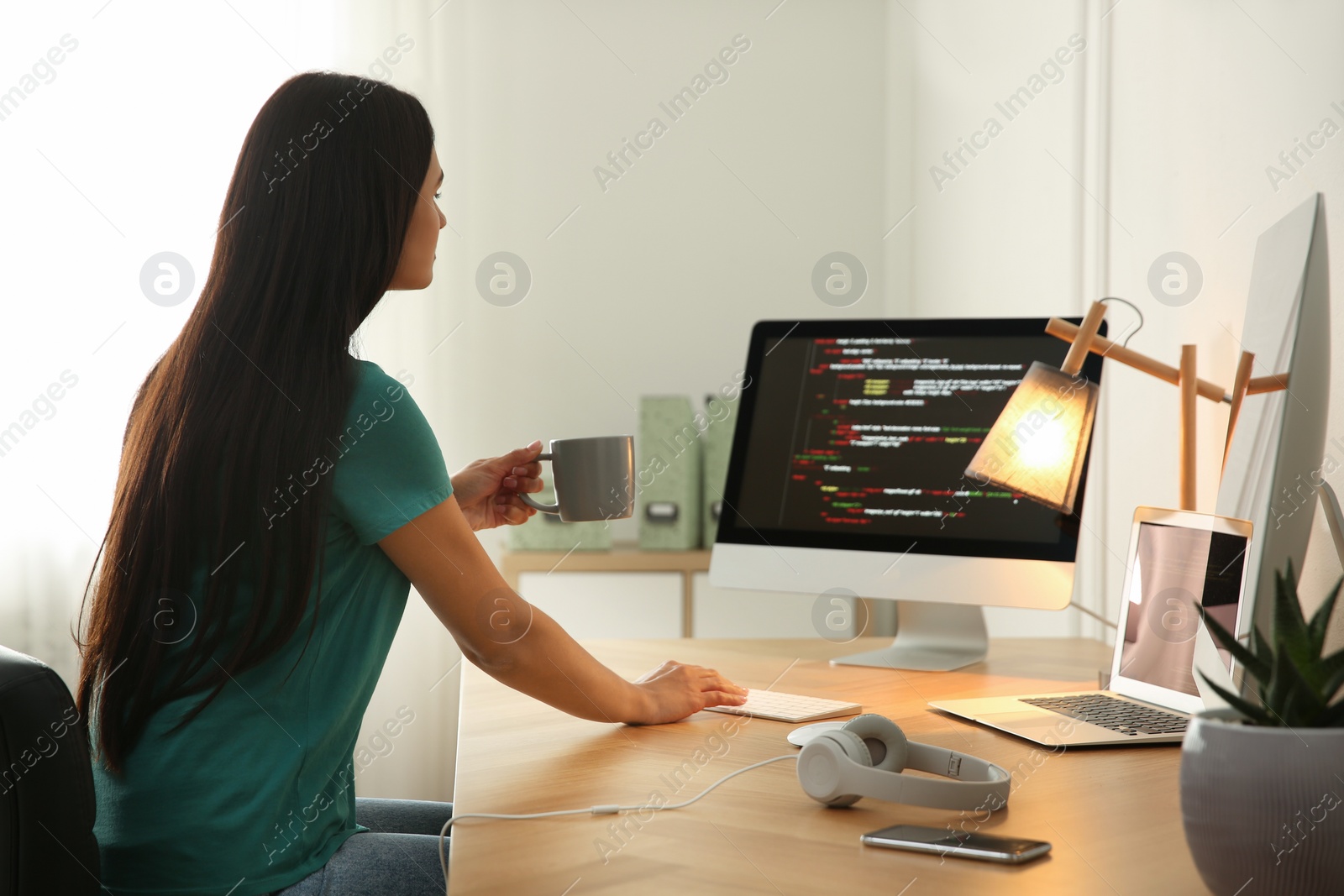 Photo of Programmer working at desk in modern office