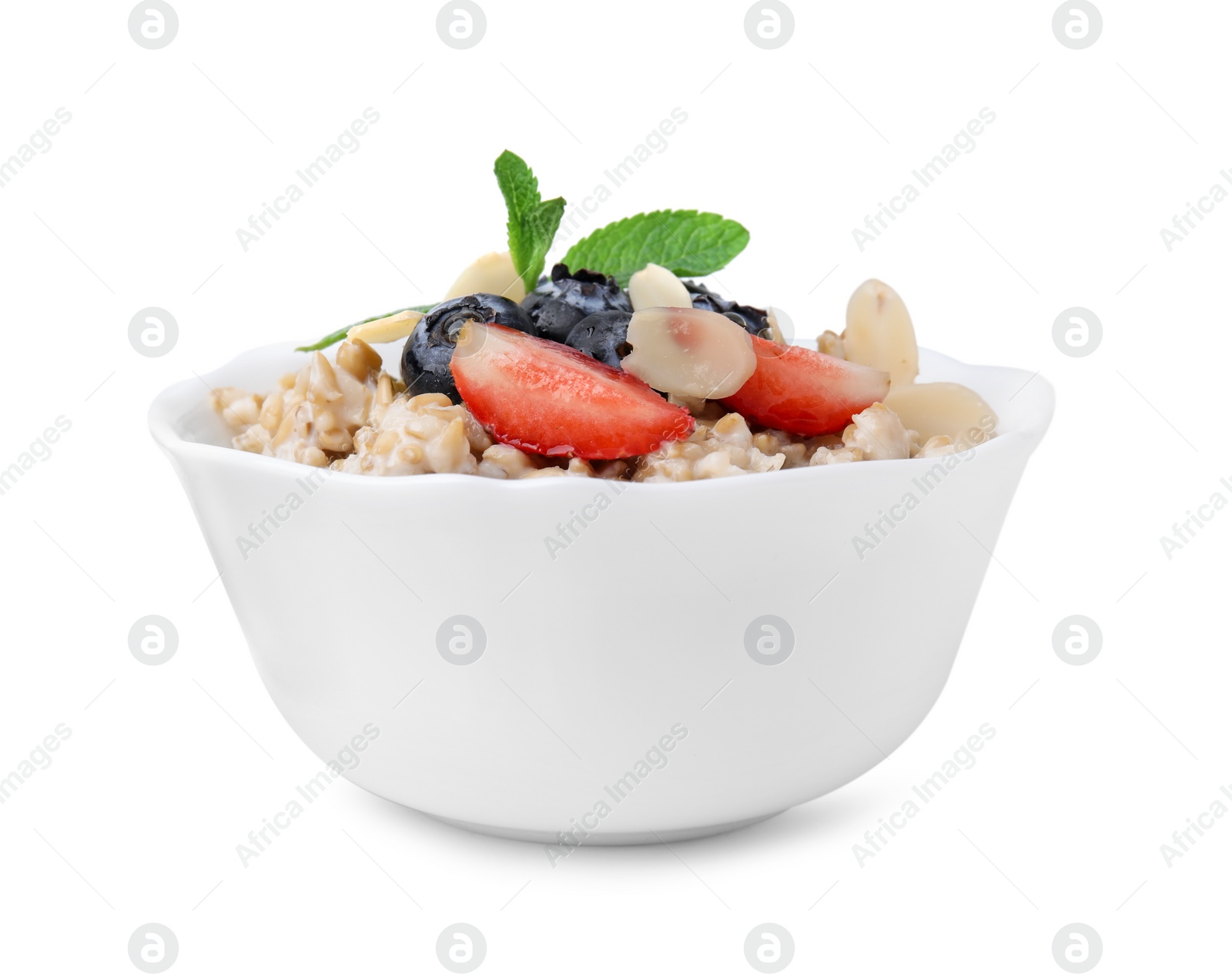 Photo of Tasty oatmeal with strawberries, blueberries and almond flakes in bowl isolated on white