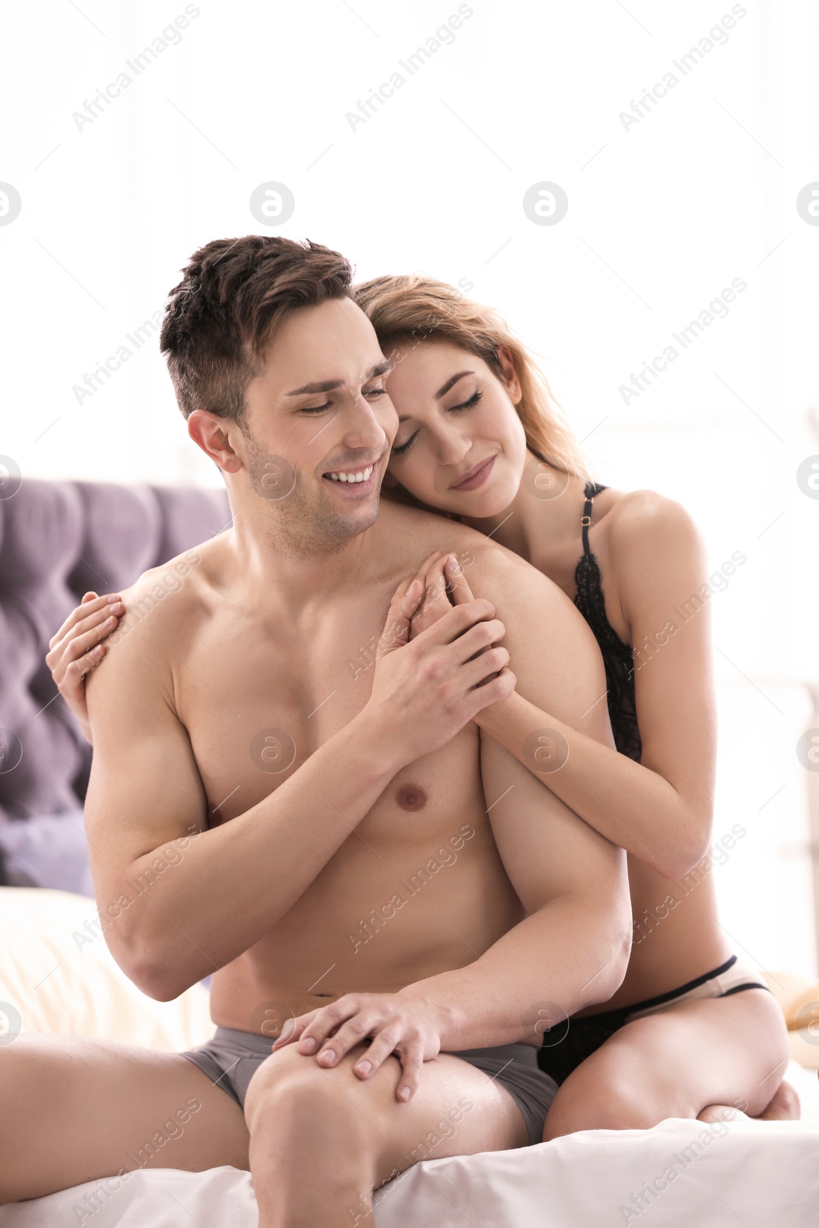 Photo of Lovely young couple on bed at home