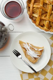 Piece of tasty homemade quince pie with powdered sugar served on white wooden table, flat lay