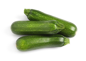 Raw ripe zucchinis on white background, top view