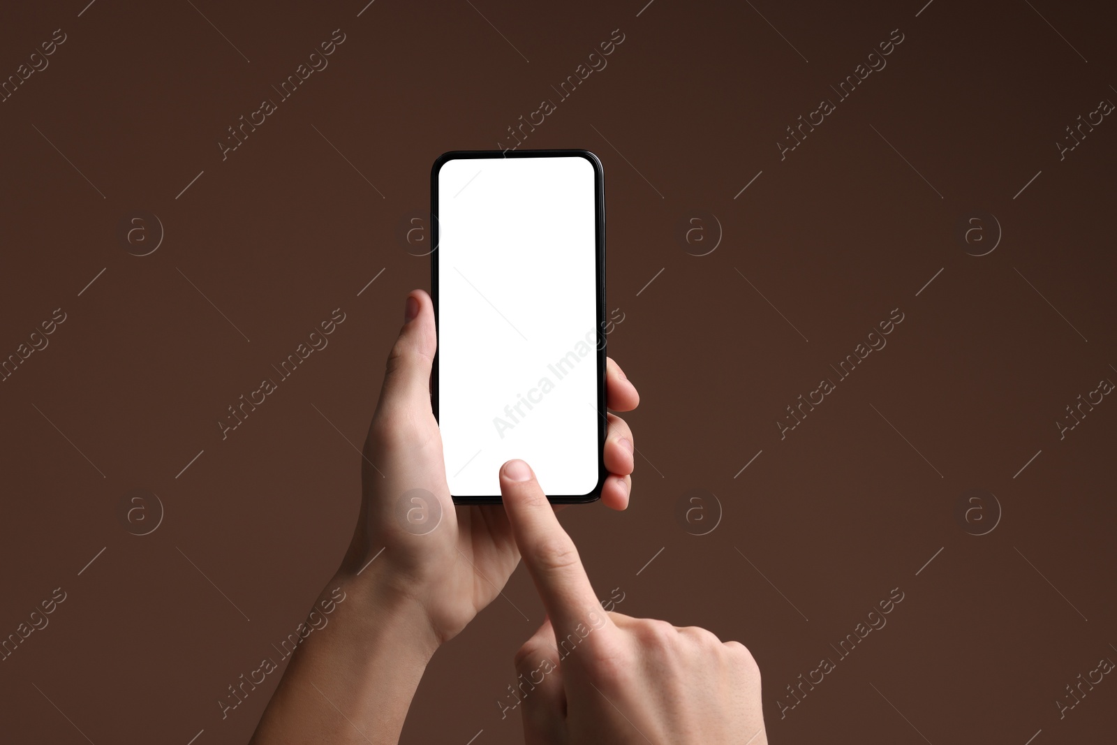 Photo of Man using smartphone with blank screen on brown background, closeup. Mockup for design