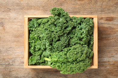 Fresh kale leaves on wooden table, top view