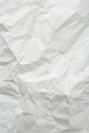 Crumpled notebook sheet as background, top view