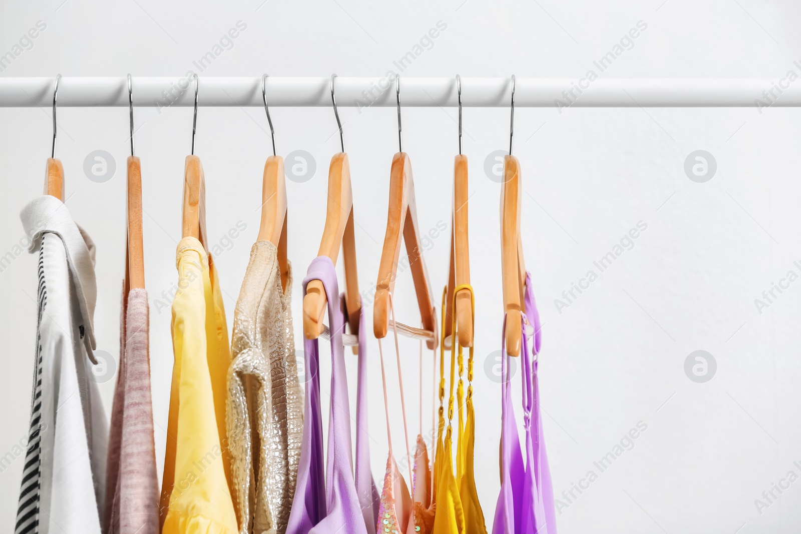 Photo of Different clothes on hangers, indoors