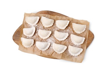 Photo of Raw dumplings (varenyky) with tasty filling and flour on white background, top view